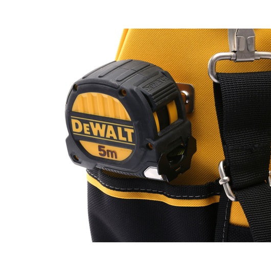 A close-up image of a DEWALT 5 meter tape measure attached to a yellow and black tool bag.