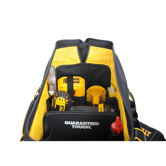 A Dewalt tool bag filled with various yellow and black power tools and accessories, with the words 'GUARANTEED TOUGH' visible on an inner flap.