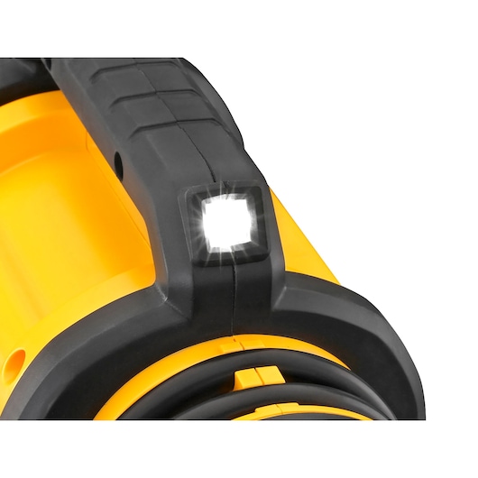 Close-up of a yellow and black DEWALT portable inflator, focusing on its built-in LED light.