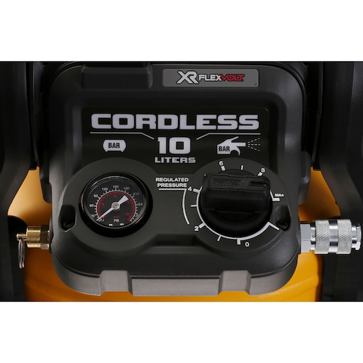 Close-up of DEWALT cordless air compressor control panel with pressure gauge and adjustment knob, 10 liters.