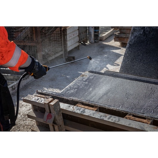 DEWALT DCCS1100N-XJ, DCCS1100N used for spraying water on construction materials at a worksite.
