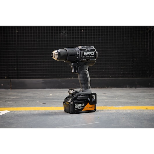 DEWALT cordless drill with McLaren branding on battery, photographed on a workshop floor.