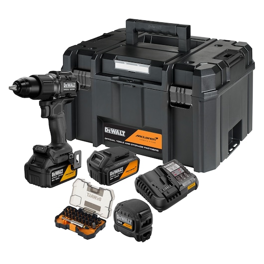 DEWALT drill set with case, batteries, charger, bit set, and McLaren branding, arranged in front of a toolbox.