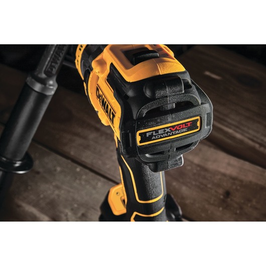 Close-up view of a DEWALT cordless drill featuring FlexVolt Advantage technology, shown on a wooden surface.