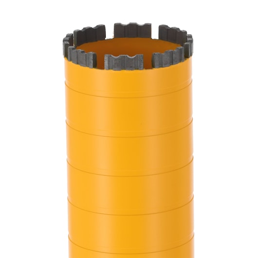 Close-up of a yellow DEWALT core drill bit with segmented cutting edge, used for drilling in hard materials.