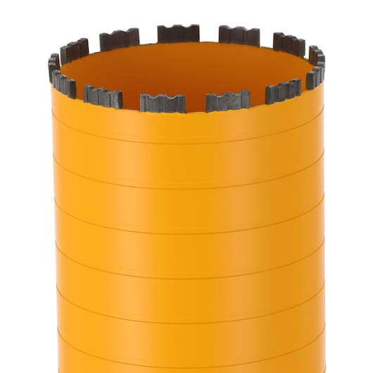 Close-up of an orange cylindrical core drill bit with segmented metal teeth around the rim.
