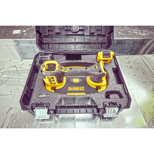 DEWALT DCE590 tool in a hard carrying case, with foam padding and accessories, viewed from above.