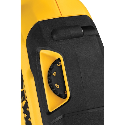Close-up view of a DEWALT power tool showing a numbered adjustment dial, primarily yellow and black in color.