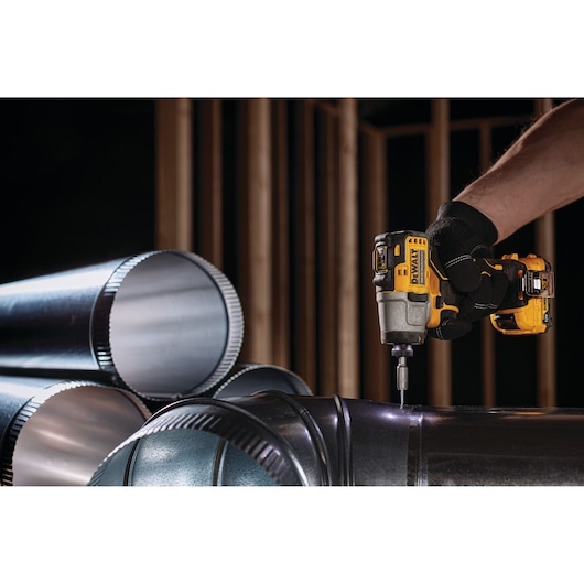 12V XR Brushless Sub-Compact Impact Driver drilling screw in to metal pipe