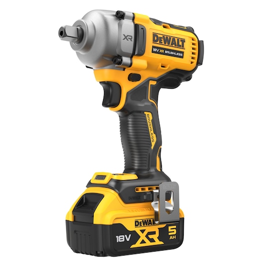 A DeWalt 18V XR Brushless cordless impact wrench with a 5Ah battery, shown in yellow and black colors with a metal clip attached.