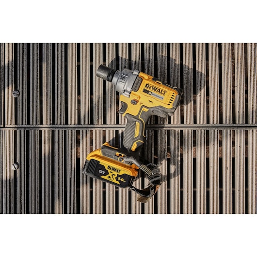 A DEWALT DCF894P2 cordless impact wrench with 18V XR 5.0Ah battery, resting on wooden slats.
