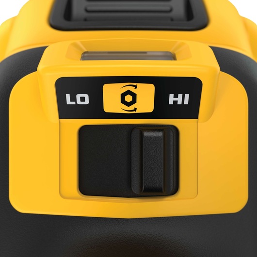 Close-up of a DEWALT tool control panel showing a switch with two speed options, labeled 'LO' for low and 'HI' for high, with a hex nut rotation symbol in the center. The panel features yellow and black colors.