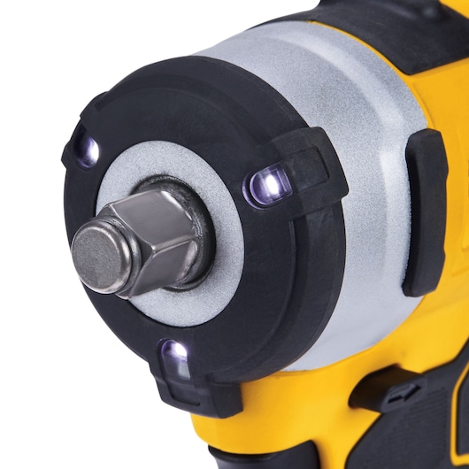 Close-up image of the front of a DEWALT cordless impact wrench, highlighting the metal drive, LED lights, and yellow and black body.