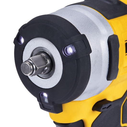 Close-up image of the front end of a DEWALT cordless impact wrench, showing the metal drive and LED lights around the head. The tool has a yellow and black body.