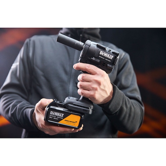 DEWALT DCF92MP2T-QW and DCF92MP2T cordless tool held in hand, photography category, black and yellow design.