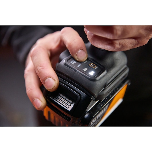 Hand adjusts DEWALT Photography tool control. Visible: DCF92MP2T-QW, DCF92MP2T SKUs.