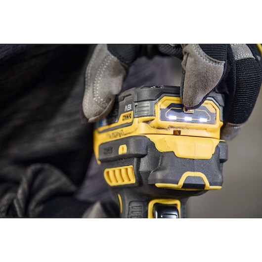 DEWALT DCG404S2T-QW, DCG404S2T photography tool close-up, worker with gloves pressing button.