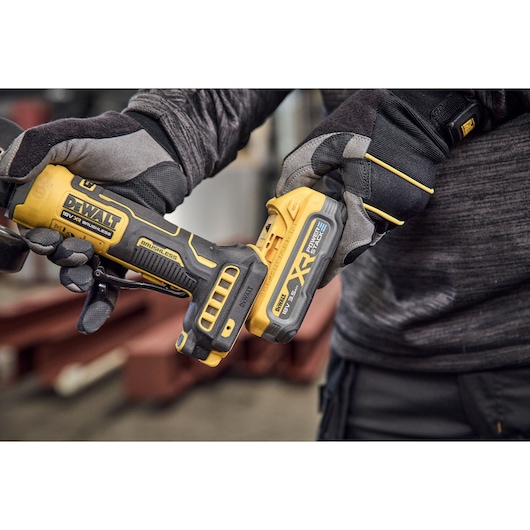 DEWALT cordless tool held, model DCG404S2T-QW and DCG404S2T shown. Photography product category.