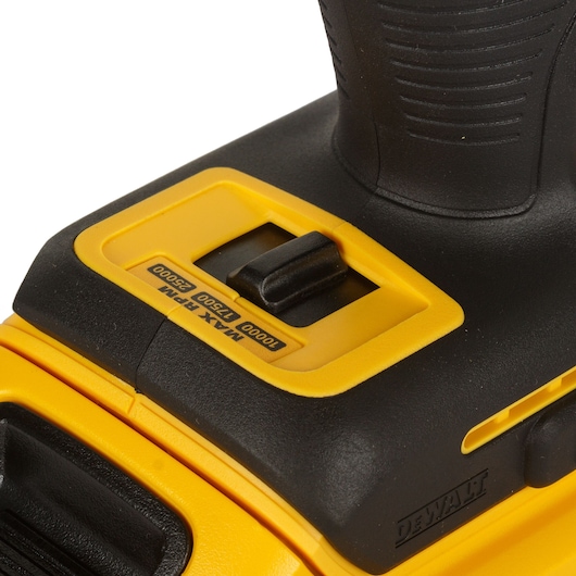 Close-up of a DEWALT power tool, showing the black and yellow speed control switch with RPM settings: 10000, 17500, 25000. The DEWALT logo is visible on the side.