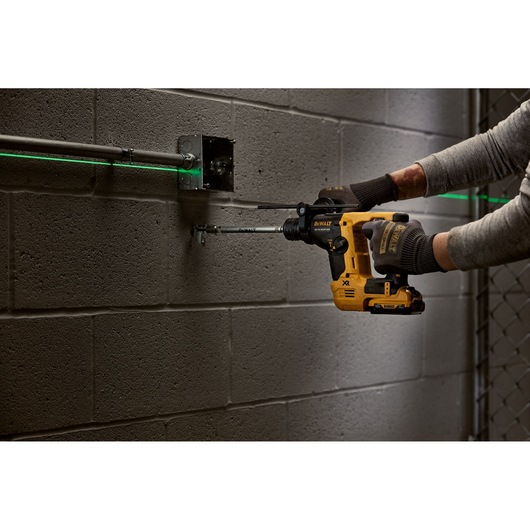 DEWALT tool in use drilling wall. SKUs: DCH072NT, DCH072N, DCH072N-XJ. Photography product category.
