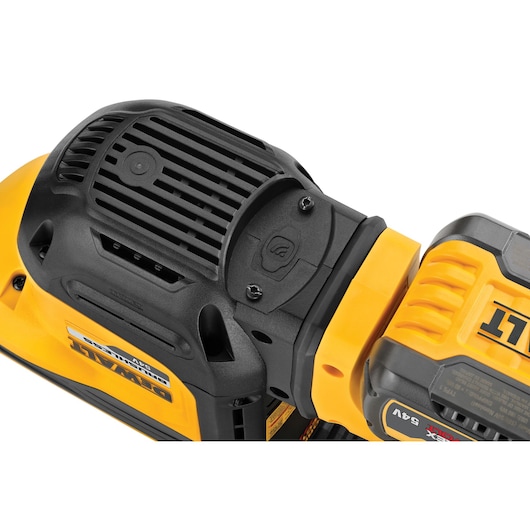 Close-up of a DEWALT power tool vent and battery, showing brand logo and textured yellow and black casing.