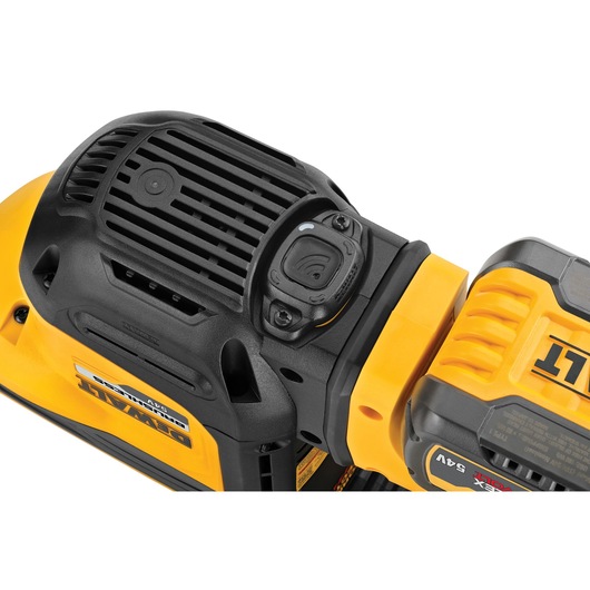 Close-up of a DEWALT power tool, showing battery and vent details in yellow and black.