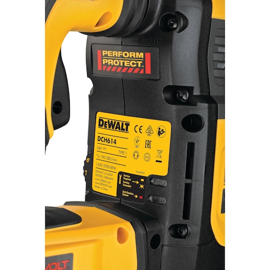 Close-up of DEWALT DCH614 power tool with yellow label and Perform Protect safety marking on black casing.