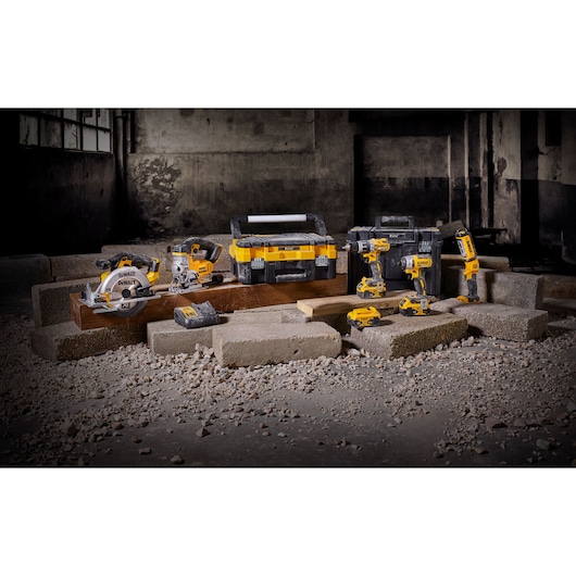 A set of yellow and black DEWALT power tools, including a cordless circular saw, angle grinder, drill, impact driver, and