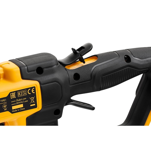 Close-up of DEWALT tool handle and trigger, showing labels and textured black and yellow grip.