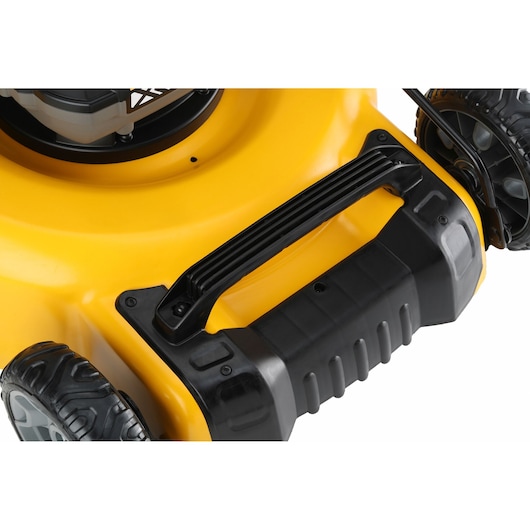 Close-up image of a yellow and black lawn mower, focusing on the sturdy handle and wheels. The lawn mower features a modern design with durable materials.
