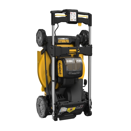 DEWALT cordless lawn mower shown upright for storage, yellow and black with battery compartment visible.