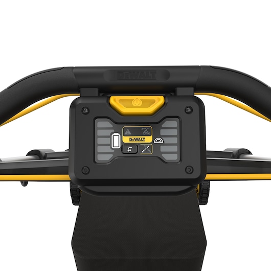 Close-up of DEWALT DCMWP500N control panel on a lawn mower handle with visible buttons and power indicator.