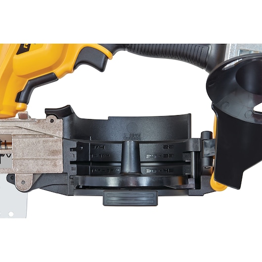 Close-up of a DEWALT tool with black plastic and metal parts and measurement markings visible on its side.