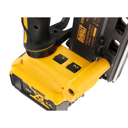 Close-up view of a DEWALT DCN692P2 cordless nailer tool showing the handle, operating switches, and 18V XR Lithium-ion battery.
