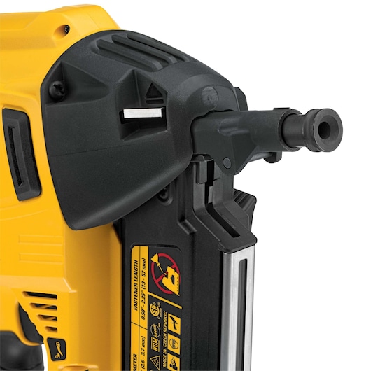 Close-up of a DEWALT nail gun showing the nozzle, body, and warning labels.