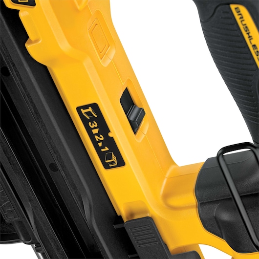 Close-up of a yellow and black DEWALT tool, showing a numbered adjustment control switch and a label with icons on the side.