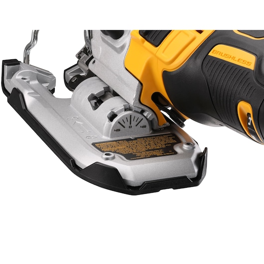 Close-up view of a DEWALT DCS335P2 brushless cordless jigsaw, focusing on the base plate and adjustment dial.