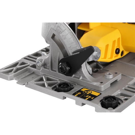 Close-up of DEWALT DCS572P2 saw base showing adjustment mechanism and angle markings.