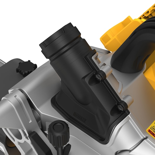 Close-up of a DEWALT miter saw dust extraction port with black and yellow parts and adjustment knobs.