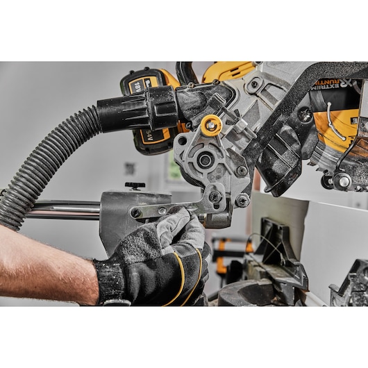 DEWALT saw in use, close-up of DCS781X2-QW and DCS781X2 SKUs, gloved hand adjusting tool, Photography category.