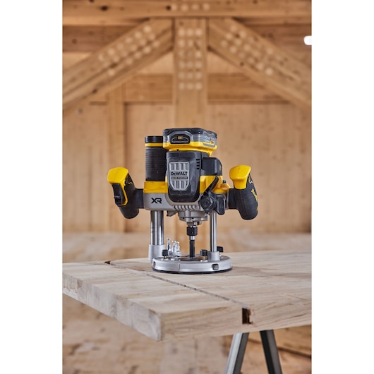 DEWALT router placed on a wooden workbench in a workshop setting.