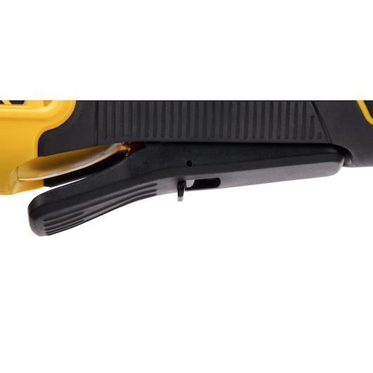Close-up view of the trigger handle on a DEWALT power tool, showing the black textured grip and part of the yellow casing.