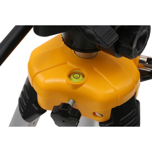 Close-up view of a yellow DEWALT tripod with a built-in bubble level, adjustment knobs, and sturdy legs designed for photography and leveling equipment.