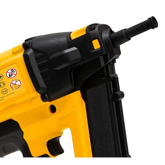 Close-up view of a DEWALT yellow and black nail gun with visible safety labels on the side.