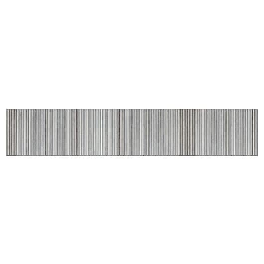 Close-up of a strip of silver metal nails arranged in parallel rows.