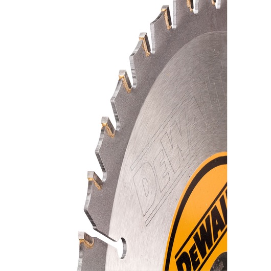 Close-up view of a circular saw blade with sharp teeth, featuring the DEWALT logo on a yellow label.