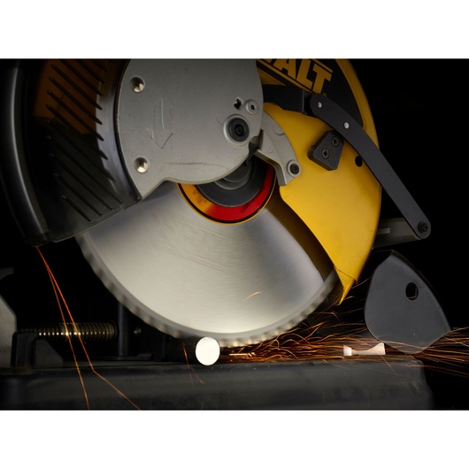 Close-up image of a DEWALT power saw blade cutting through metal, producing sparks.