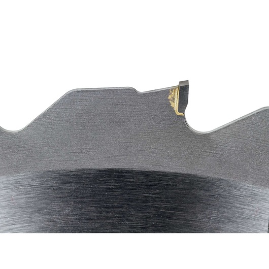 Close-up view of a DEWALT DT1953 circular saw blade tooth, showing the metal finish and a bit of residue on the tip.
