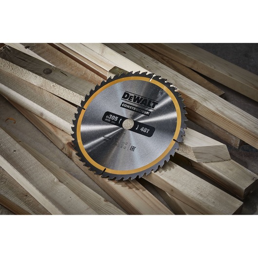 DEWALT DT1959 circular saw blade with 48 teeth placed on wooden beams for construction.