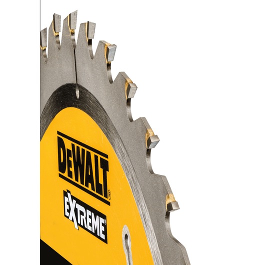 Close-up of a DEWALT Extreme circular saw blade with sharp teeth and yellow label.
